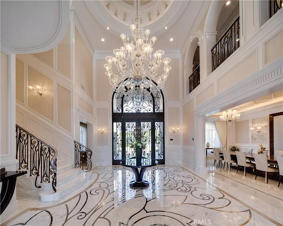 Foyer with a chandelier and stairs.