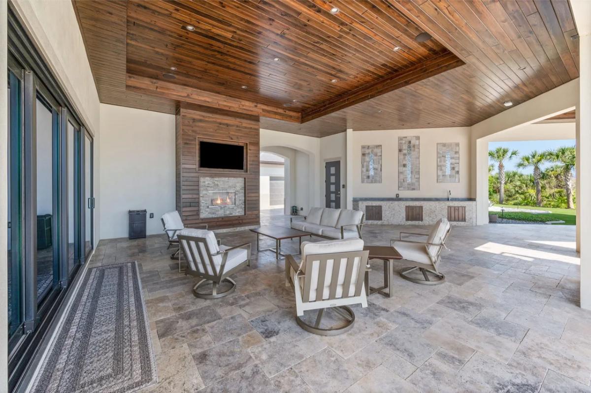 Covered patio with a fireplace.