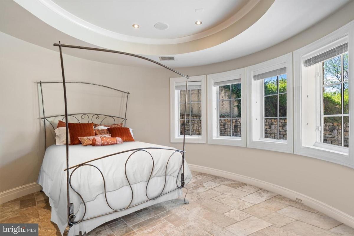 Bedroom with a large bed and glass windows.