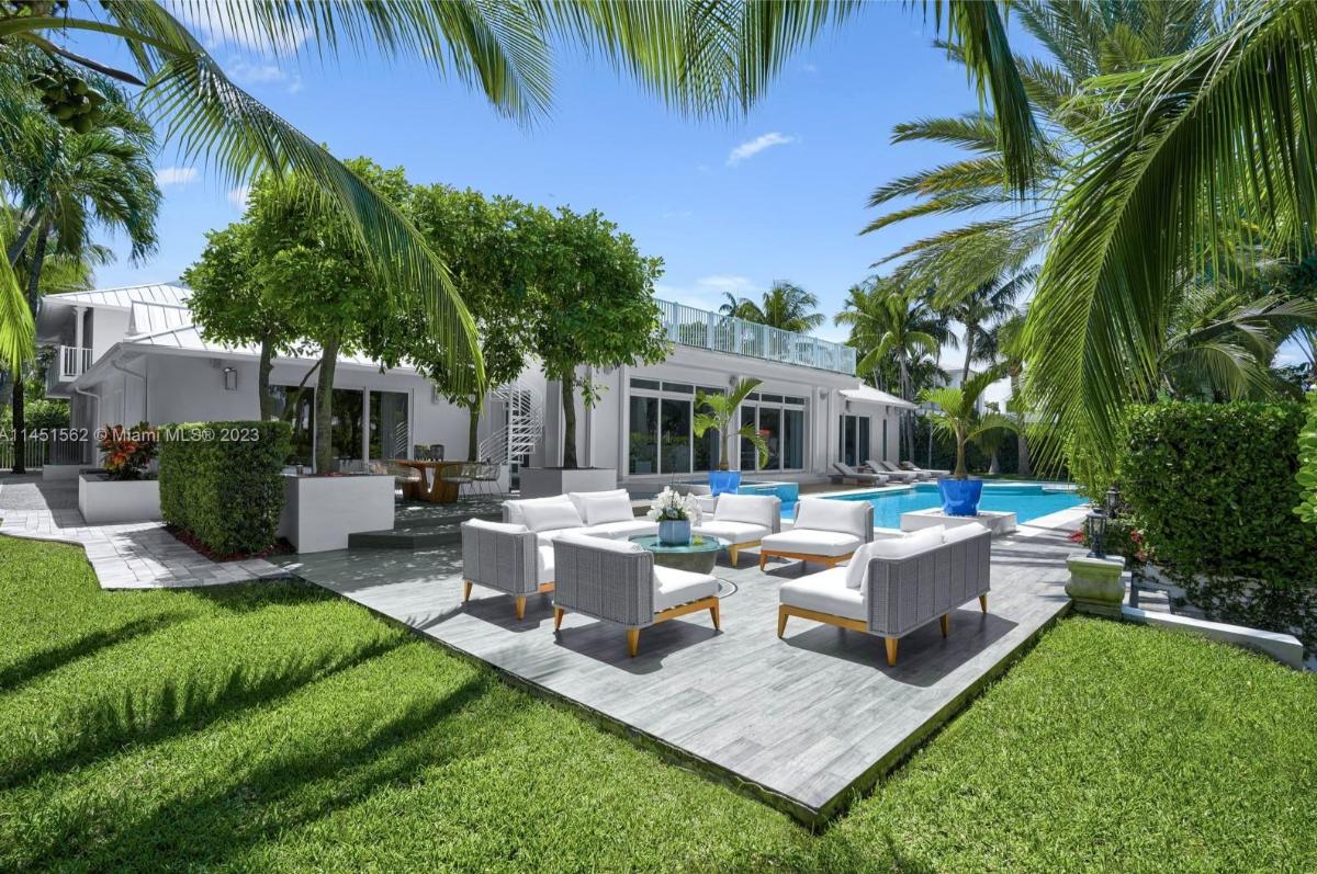 Patio on a deck with a table and chairs.