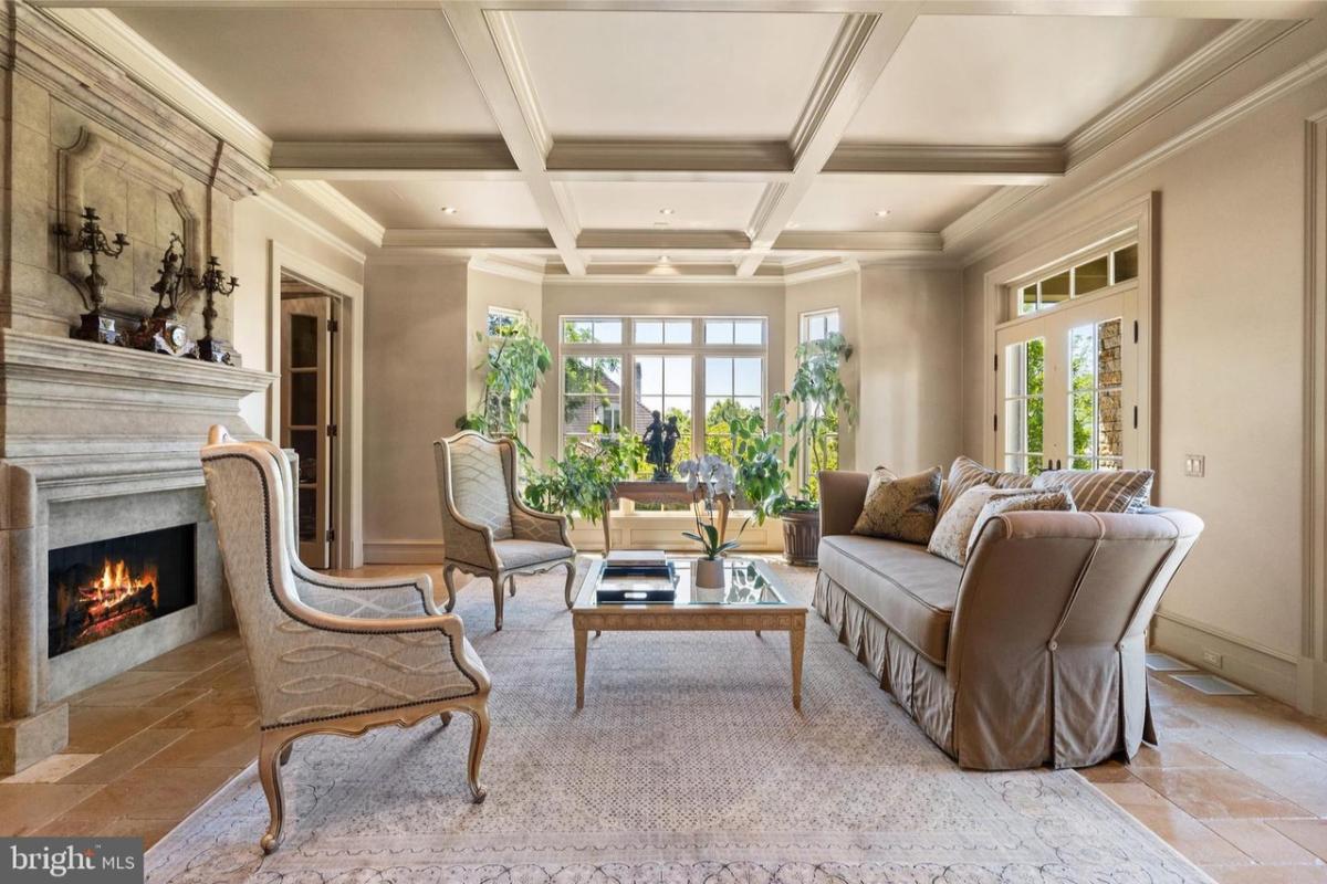 Living room with a fireplace and coffered ceilings.