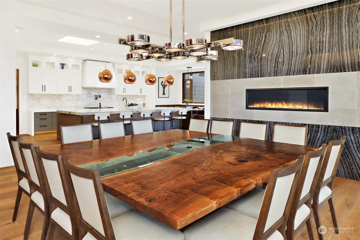 Dining room with a wood table and a fireplace.