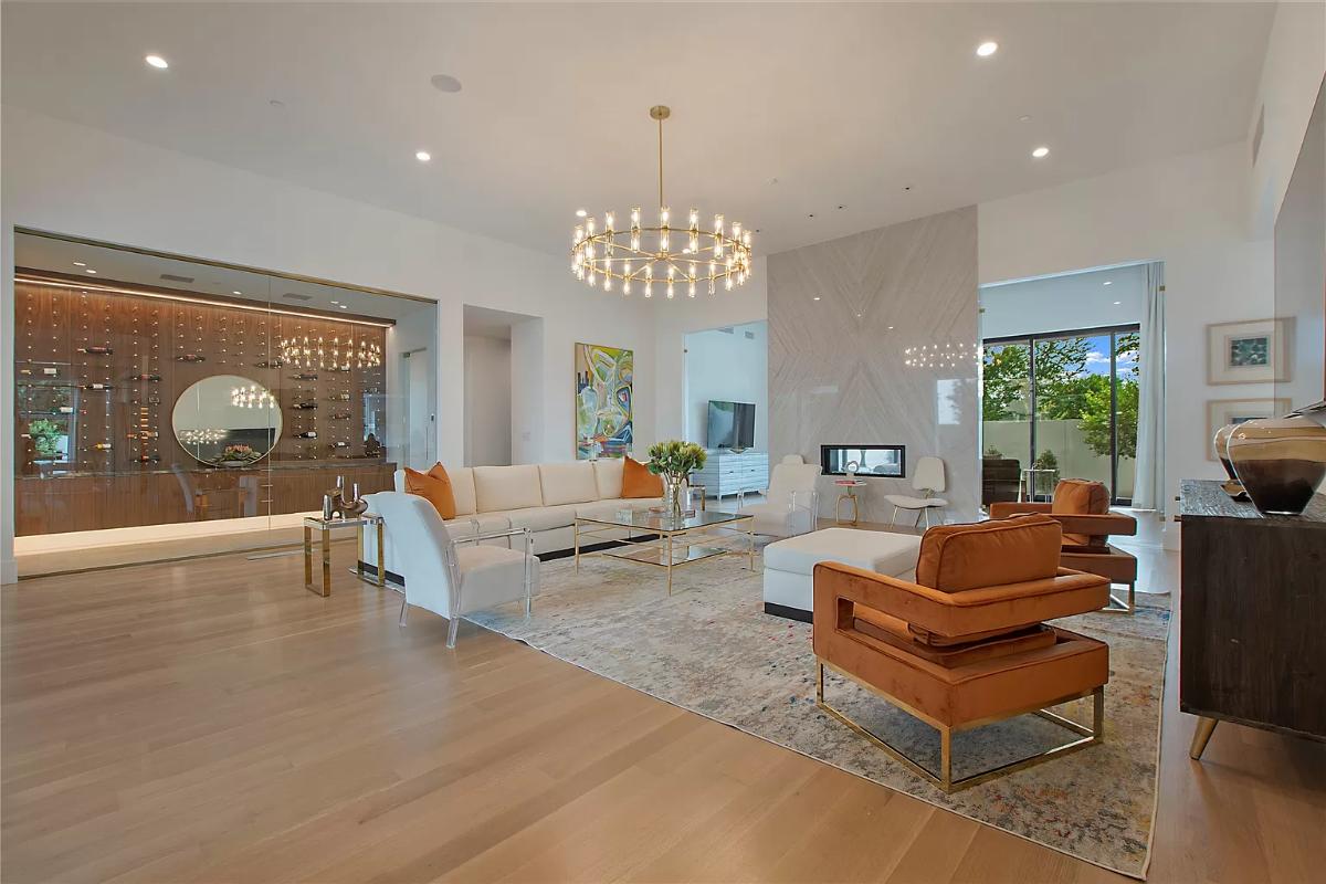 Living room with hardwood floors and a chandelier.