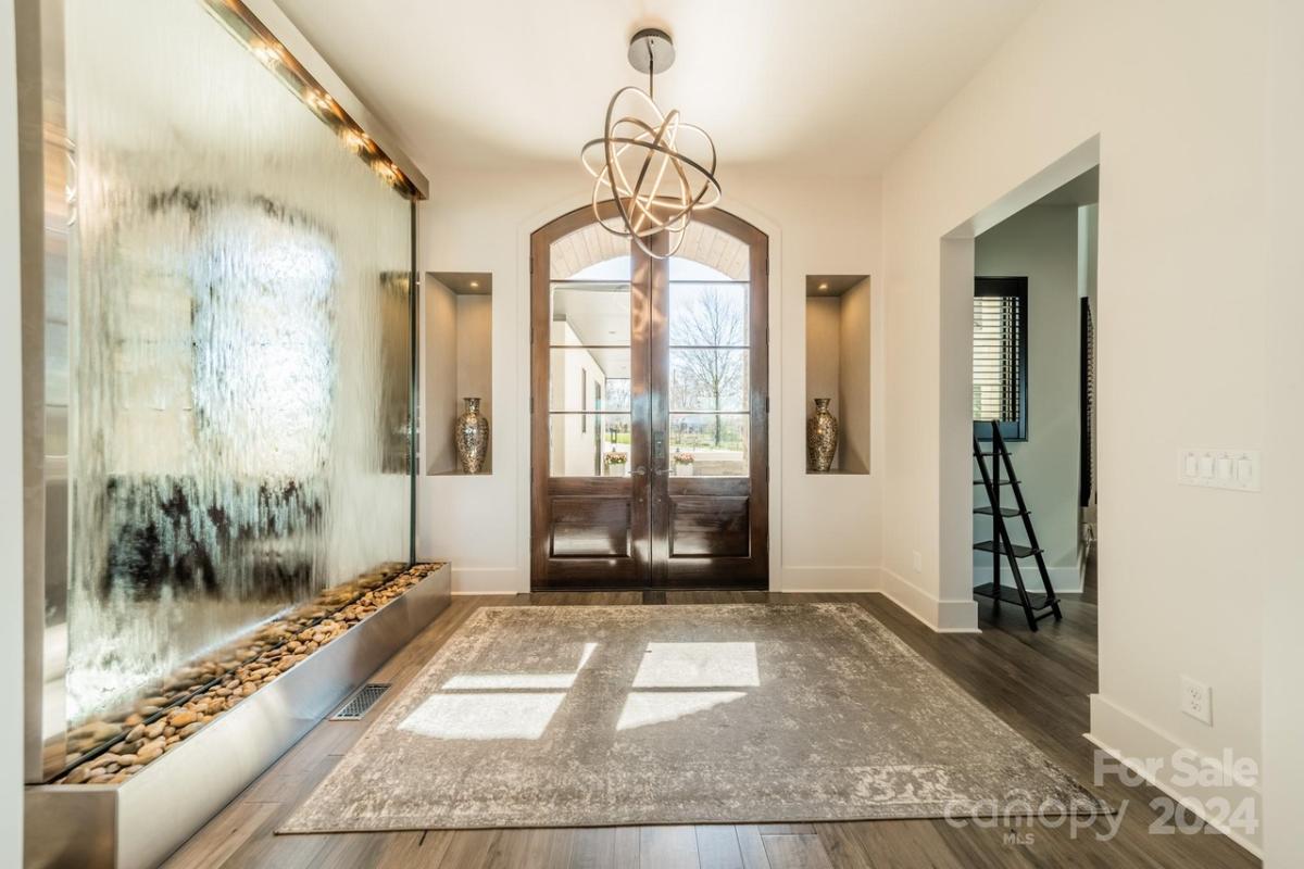 Foyer with a custom wood door.