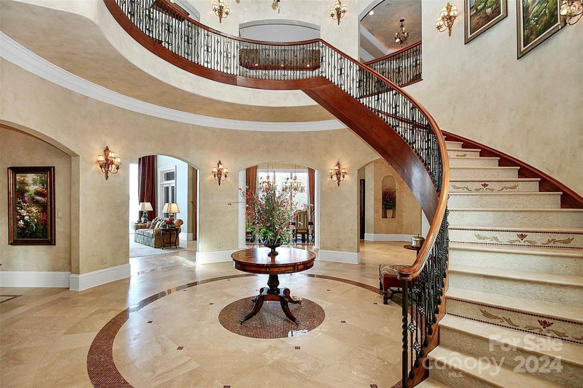 Foyer with tile floors and stairs.