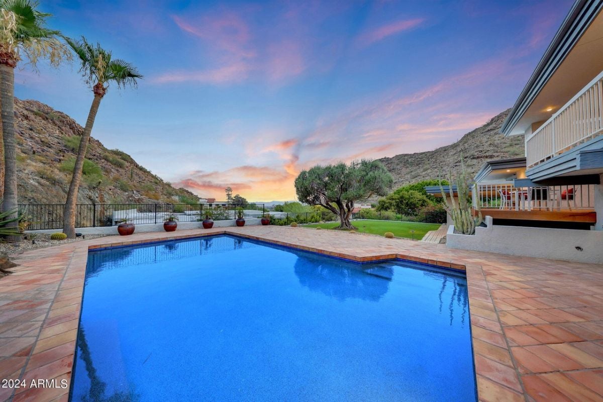 A swimming pool with plants and trees.