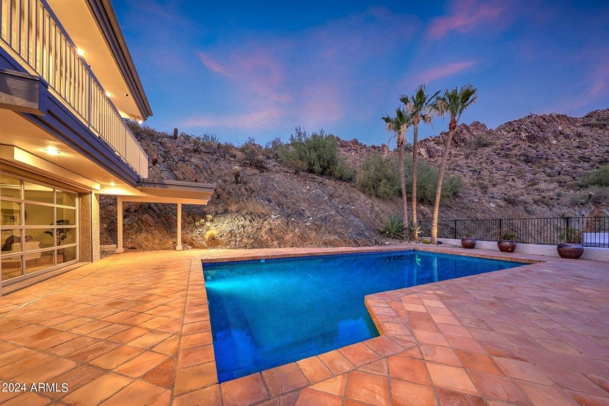 A swimming pool with plants and trees.
