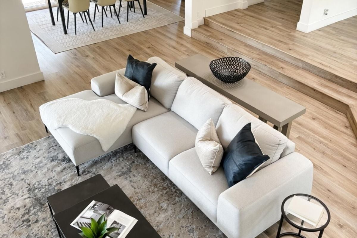 A living room with couches adorned with pillows, a rug, and a center table.
