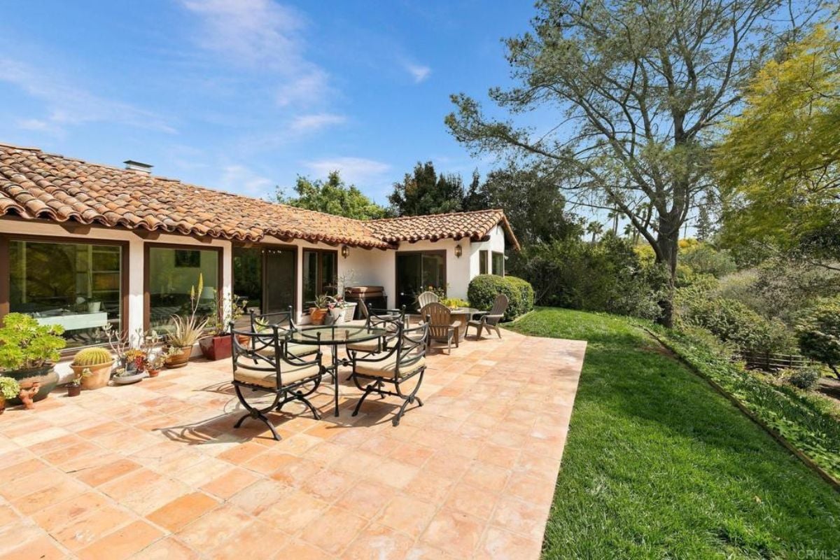 A patio with tables and chairs.