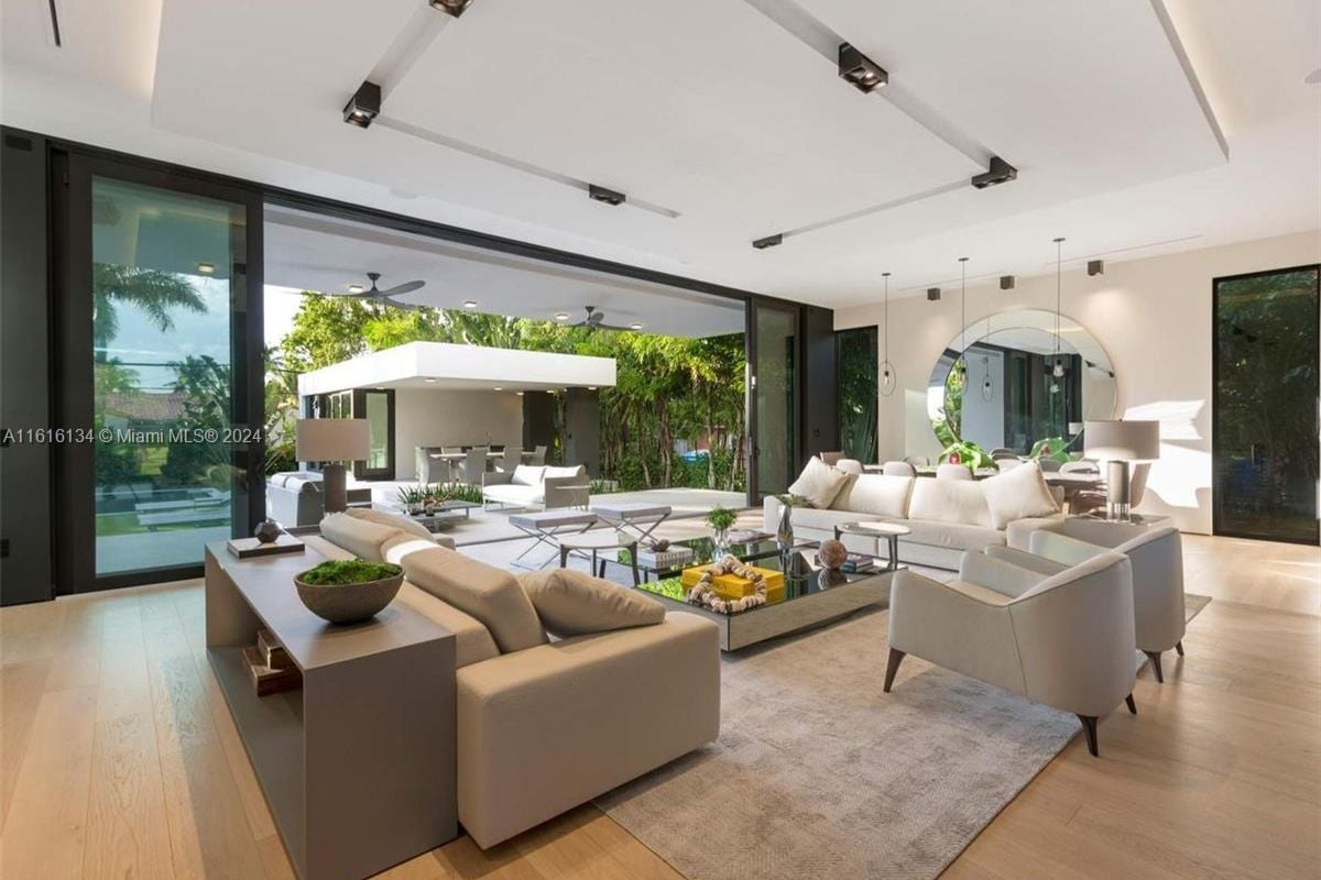A living room with couches, chairs, a rug, and a center table.