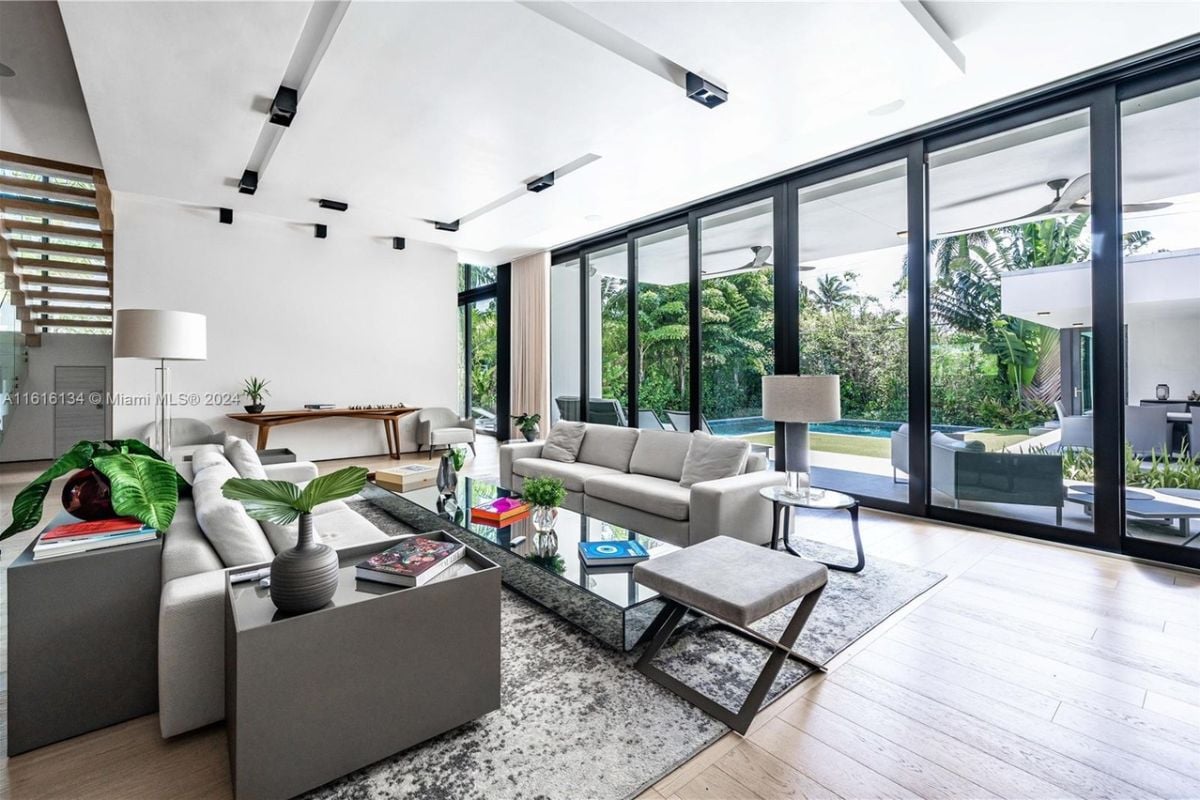 A living room with couches, chairs, a rug, and a center table.