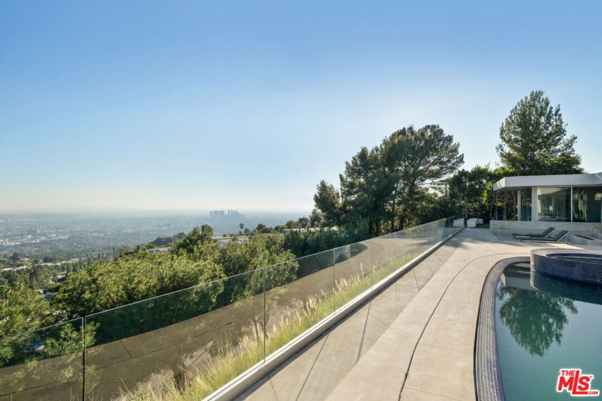 A swimming pool with a glass fence.