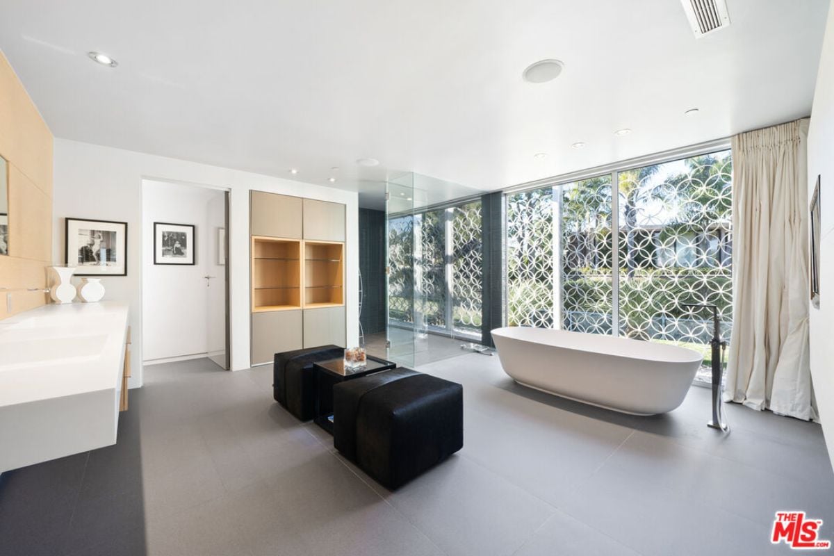 A bathroom with a countertop, cabinet, and bathtub.