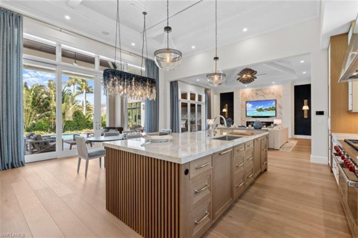 A great room with living space, a dining area, and a kitchen.