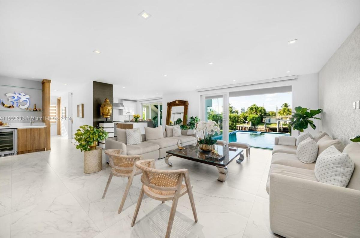 Living room with tile flooring and sliding glass doors.