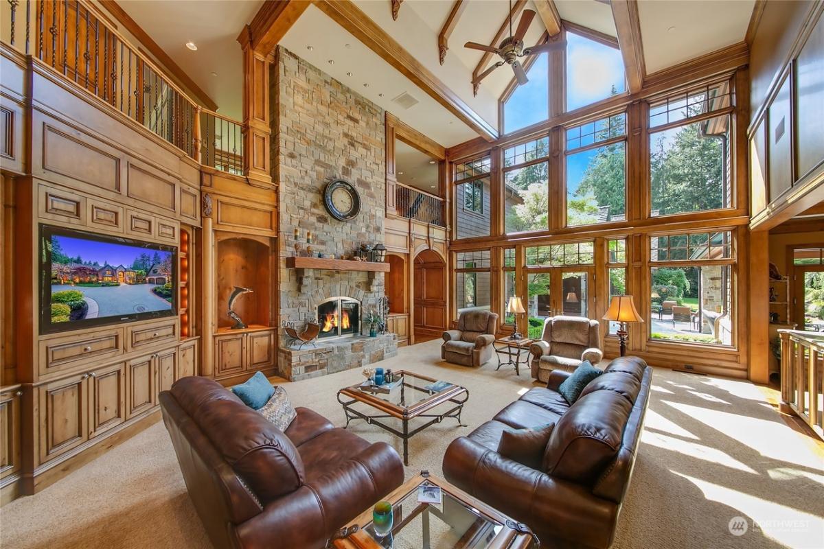 Living room with soaring ceilings and a fireplace.