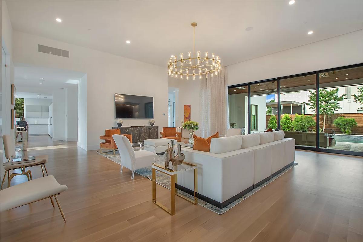 Living room with hardwood floors and a chandelier.
