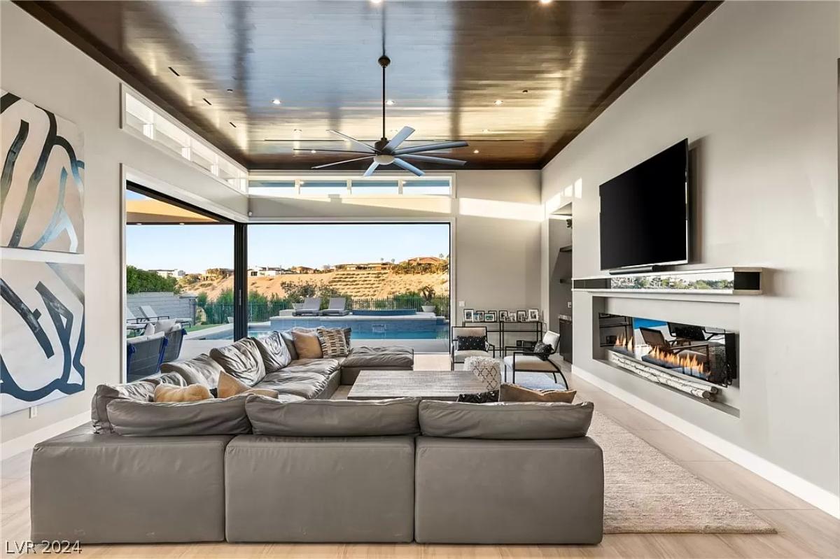 Living room with couches and a fireplace.