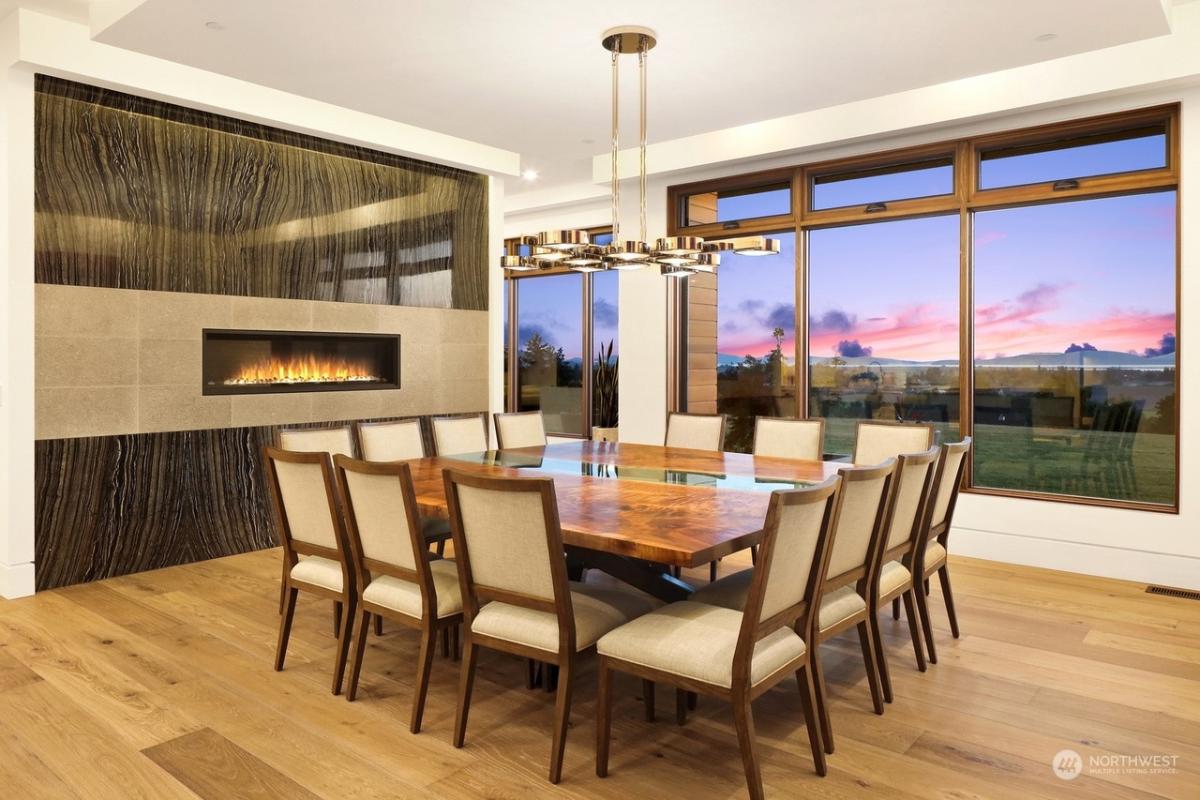 Dining room with a wood table and a fireplace.