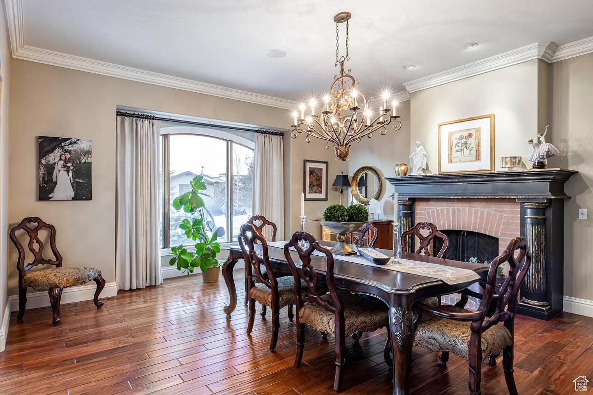 Dining room with a chandelier and a fireplace.