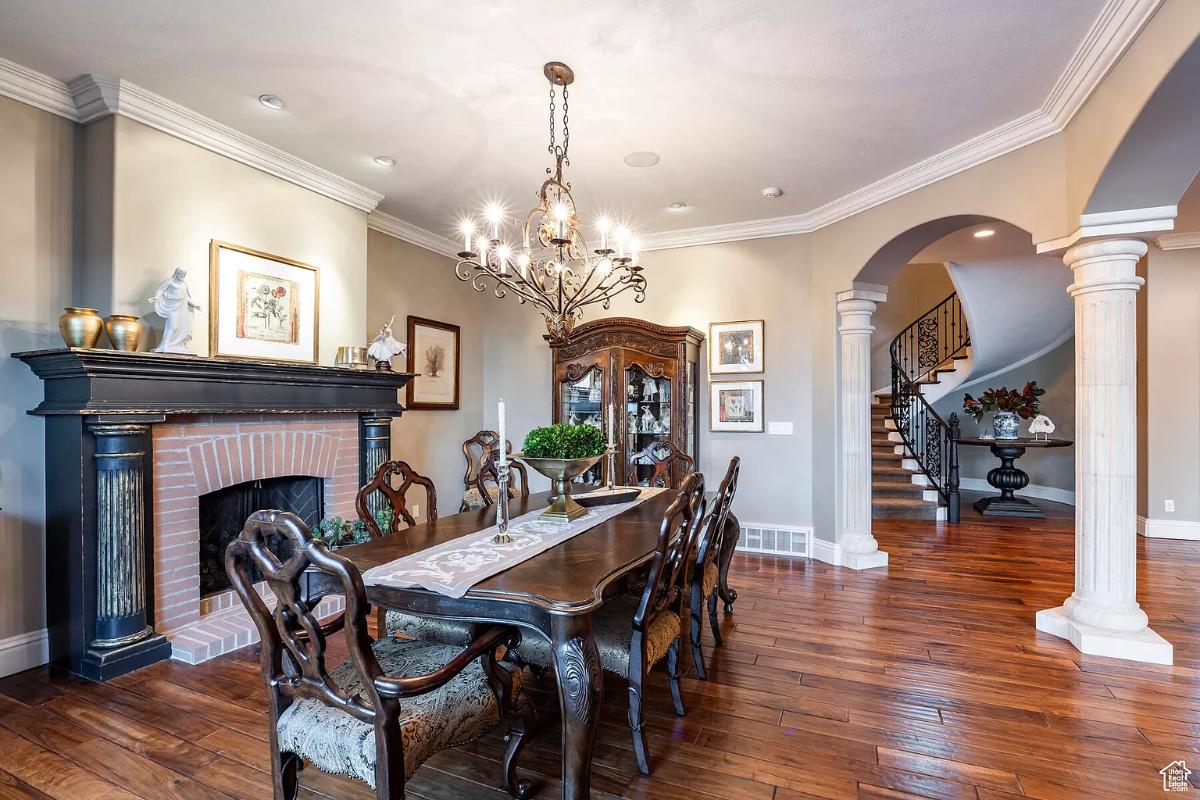 Dining room with a chandelier and a fireplace.