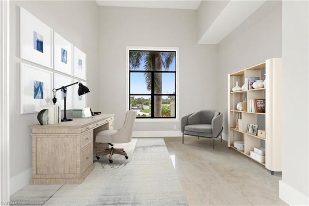 A home office with a window, shelves, a desk, and chairs.