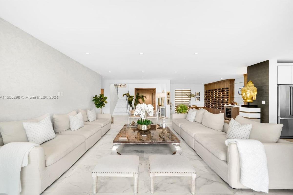 Living room with tile flooring and custom lighting.