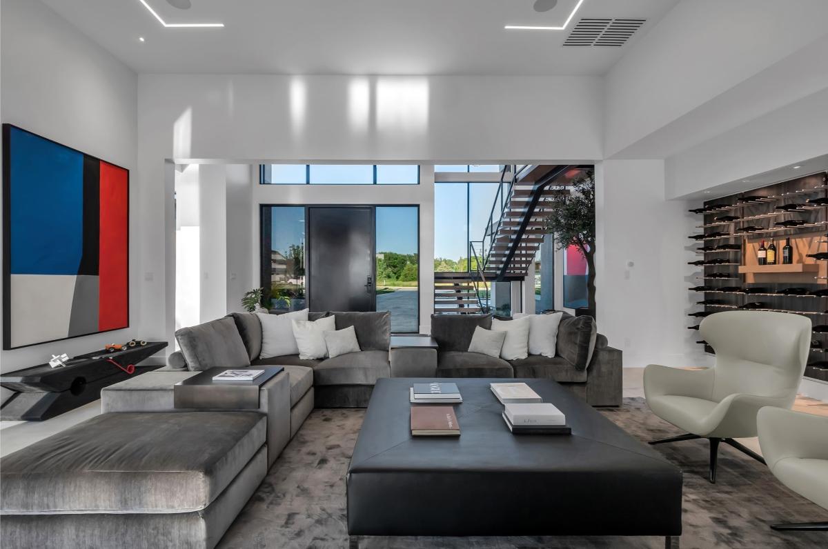 Living room with couches and custom lighting.