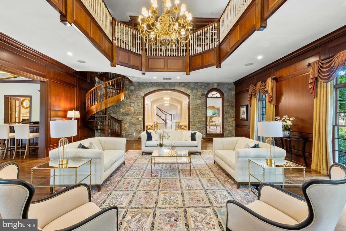 Living room with couches and a chandelier.