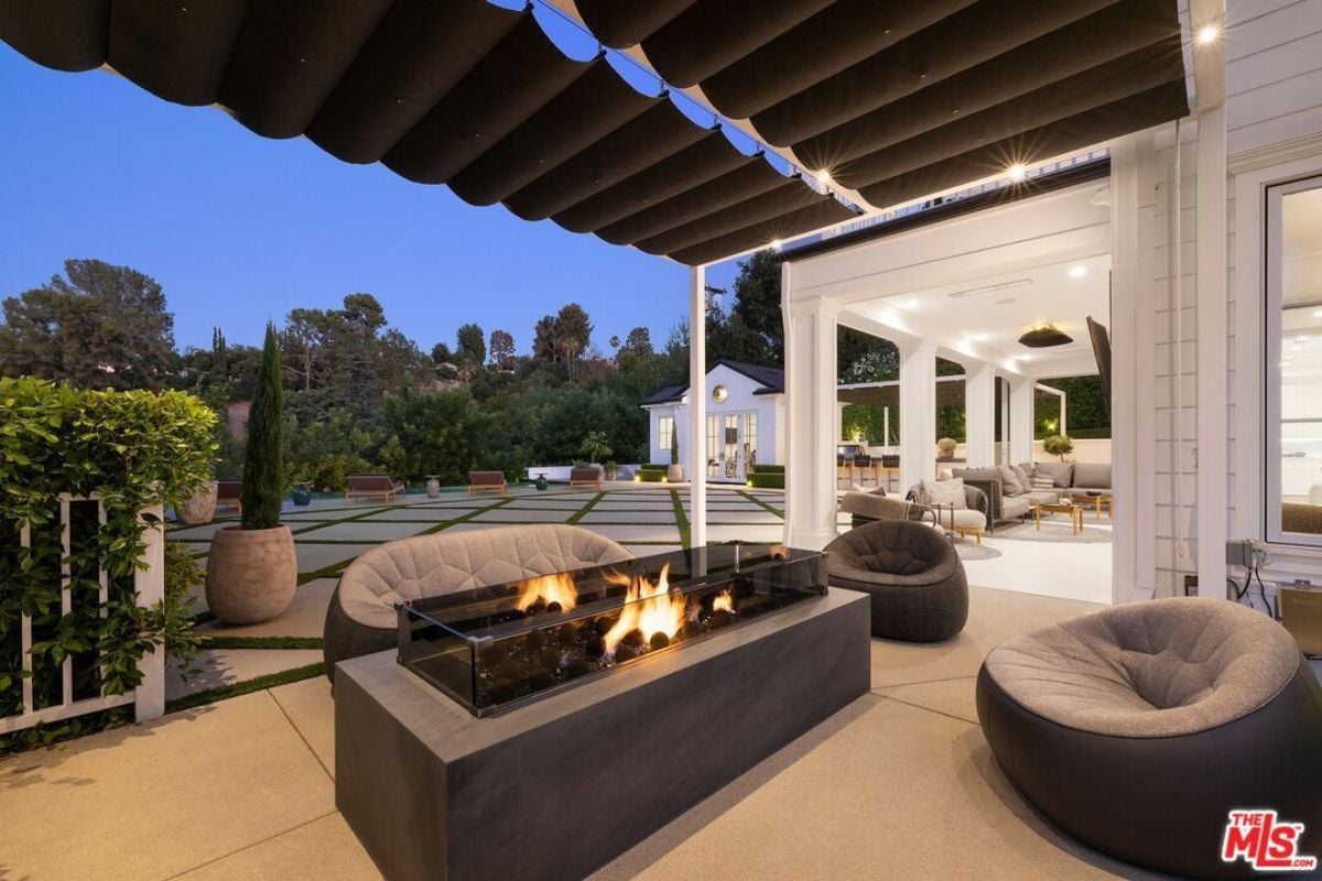 A patio with chairs and a fire pit.