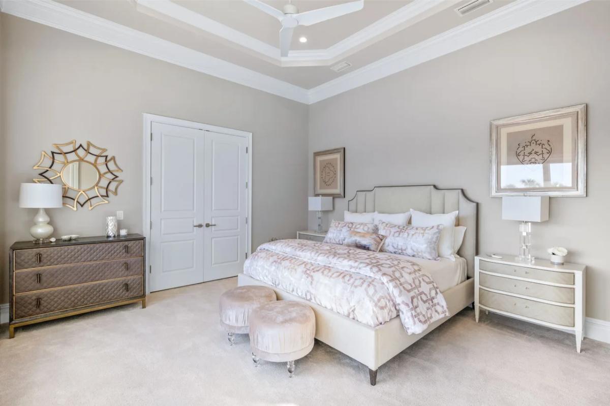 Bedroom with a large bed and carpet flooring.