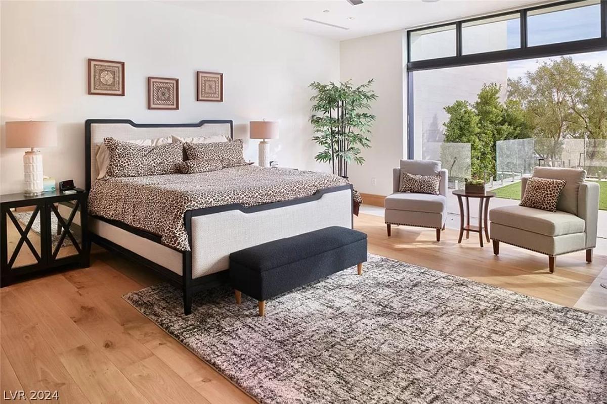 Bedroom with hardwood floors and glass walls.
