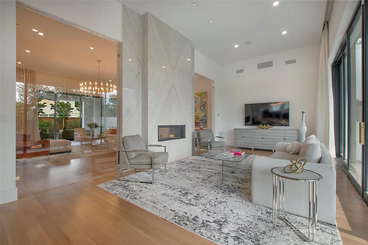 Living room with hardwood floors and a fireplace.