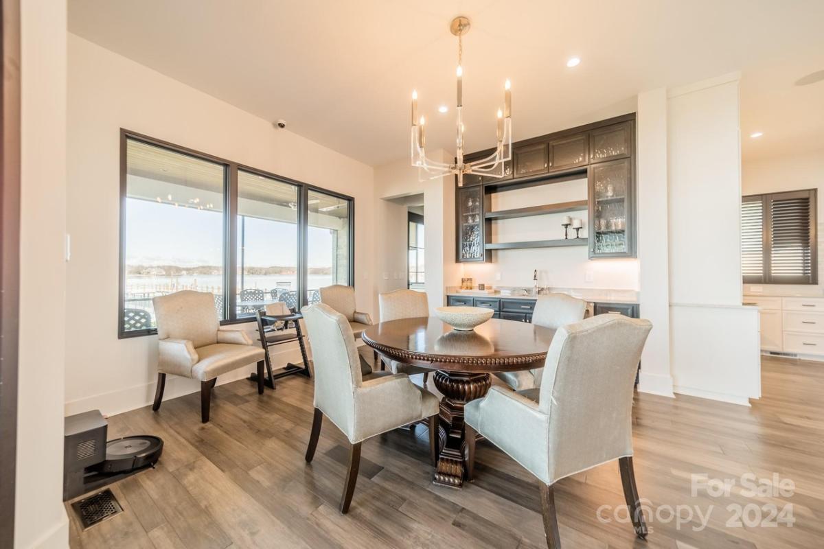 Dining room with a round wood table and chairs.