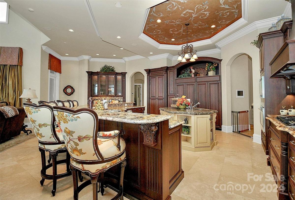 Kitchen with custom cabinetry, a counter breakfast bar and a center island prep area.