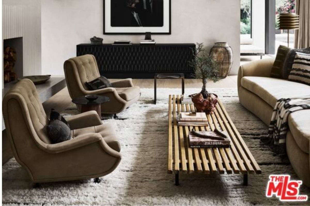 A living room with a couch, chairs, and a center table.