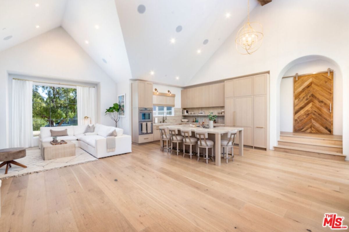 A great room seamlessly integrating living space, dining area, and kitchen.