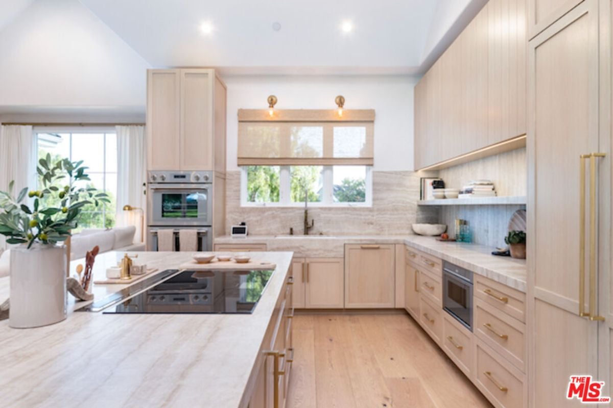 A kitchen equipped with countertops, cabinets, a sink, and kitchen appliances.