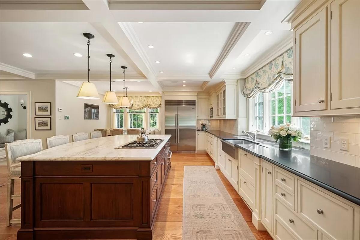 Kitchen with custom cabinetry and a counter breakfast bar.