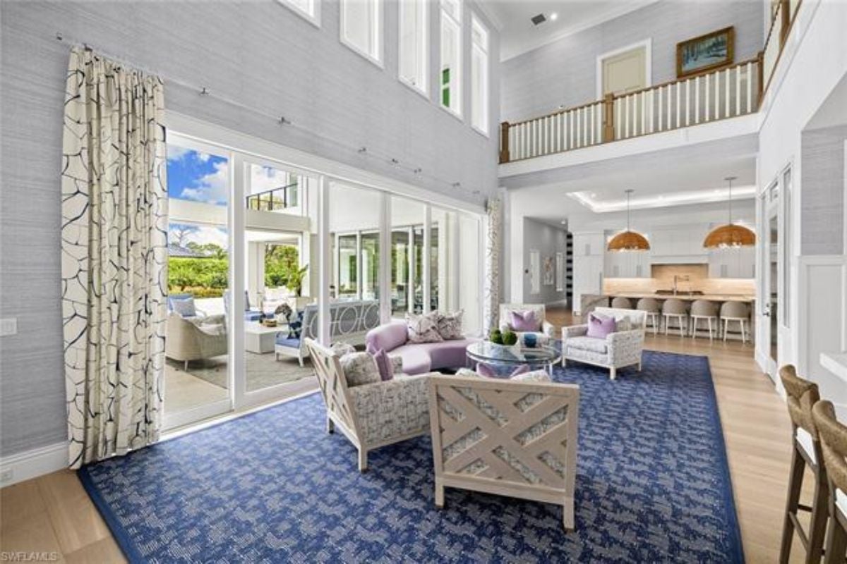 A living room with a rug, chairs, and a round center table.