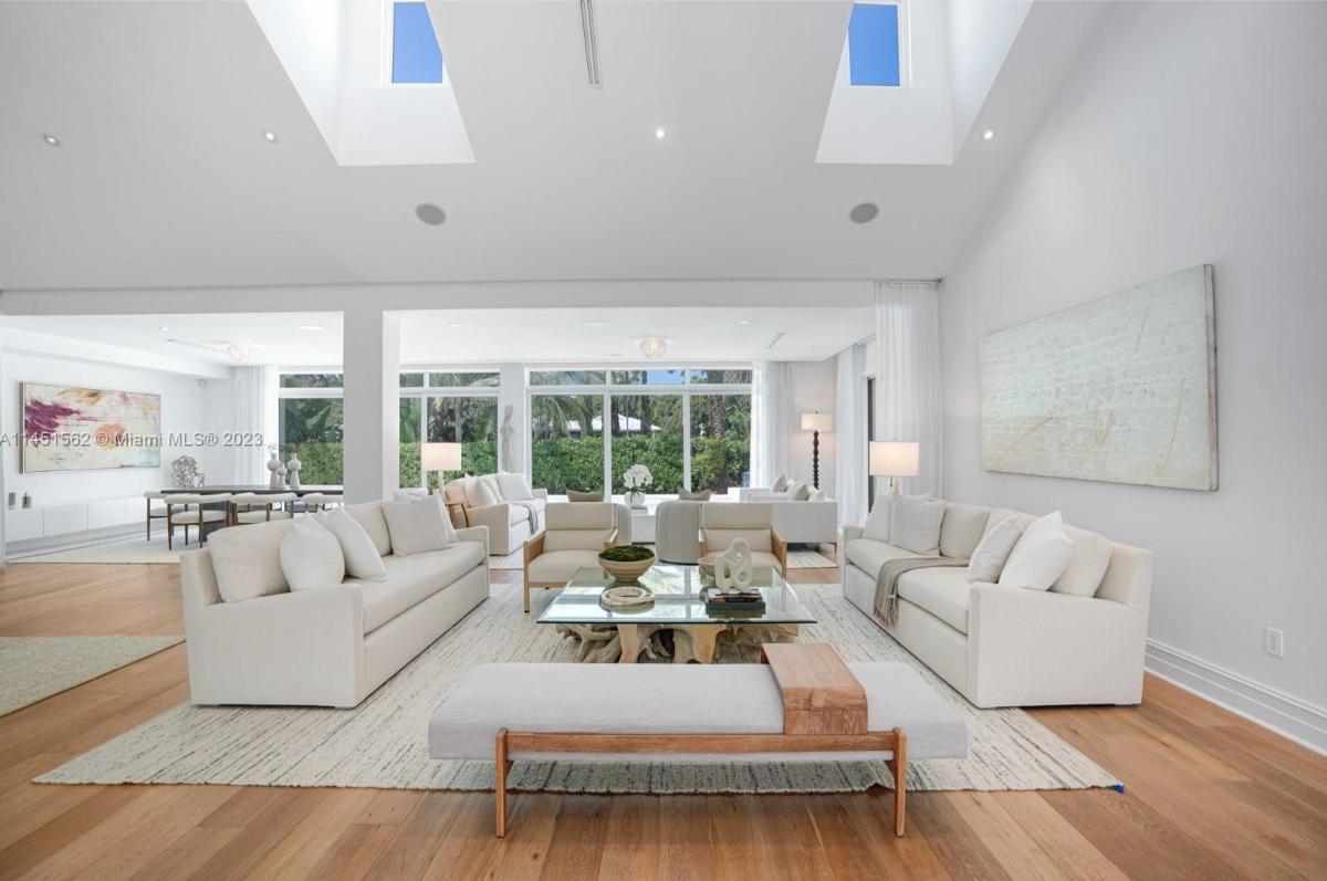 Living room with hardwood flooring and skylights.