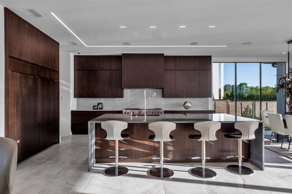 Kitchen with custom cabinetry and counter breakfast bar.