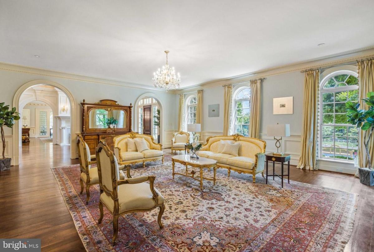 Living room with a hardwood flooring and a chandelier.