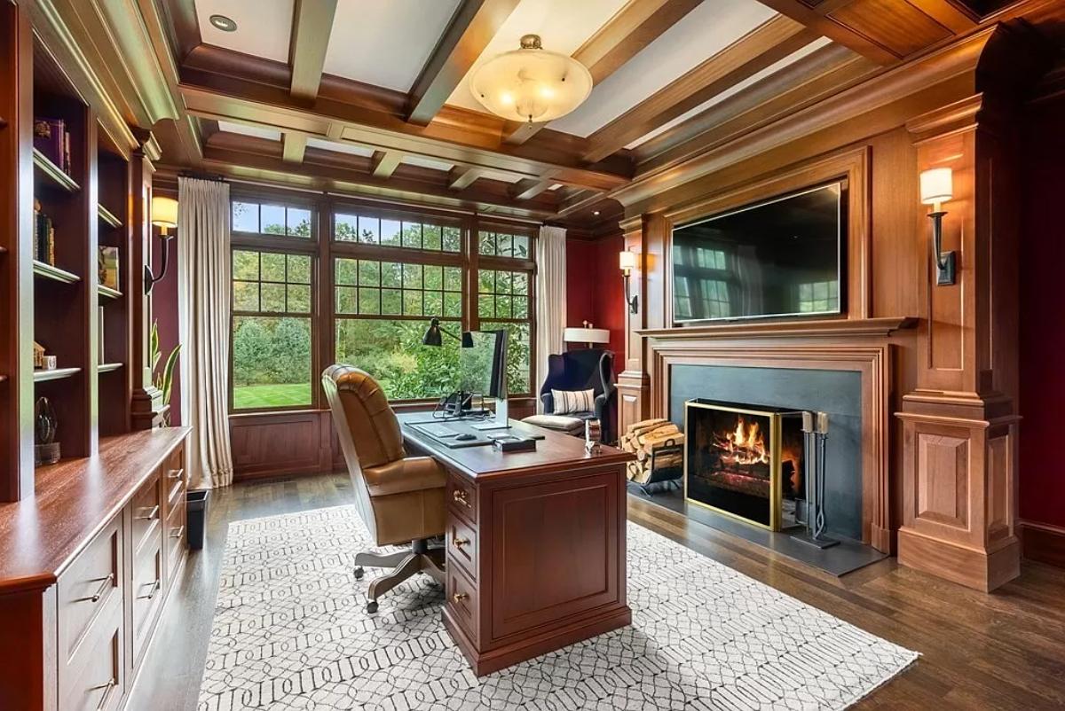 Home office with coffered ceiling and a fireplace.