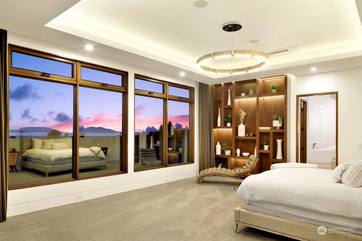 Bedroom with carpet flooring and glass windows.
