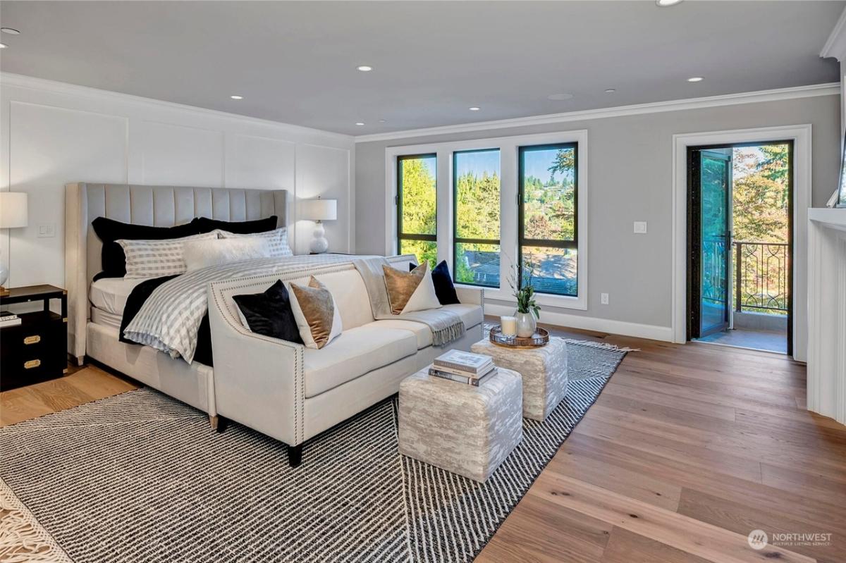 Bedroom with hardwood floors, glass windows and glass doors.