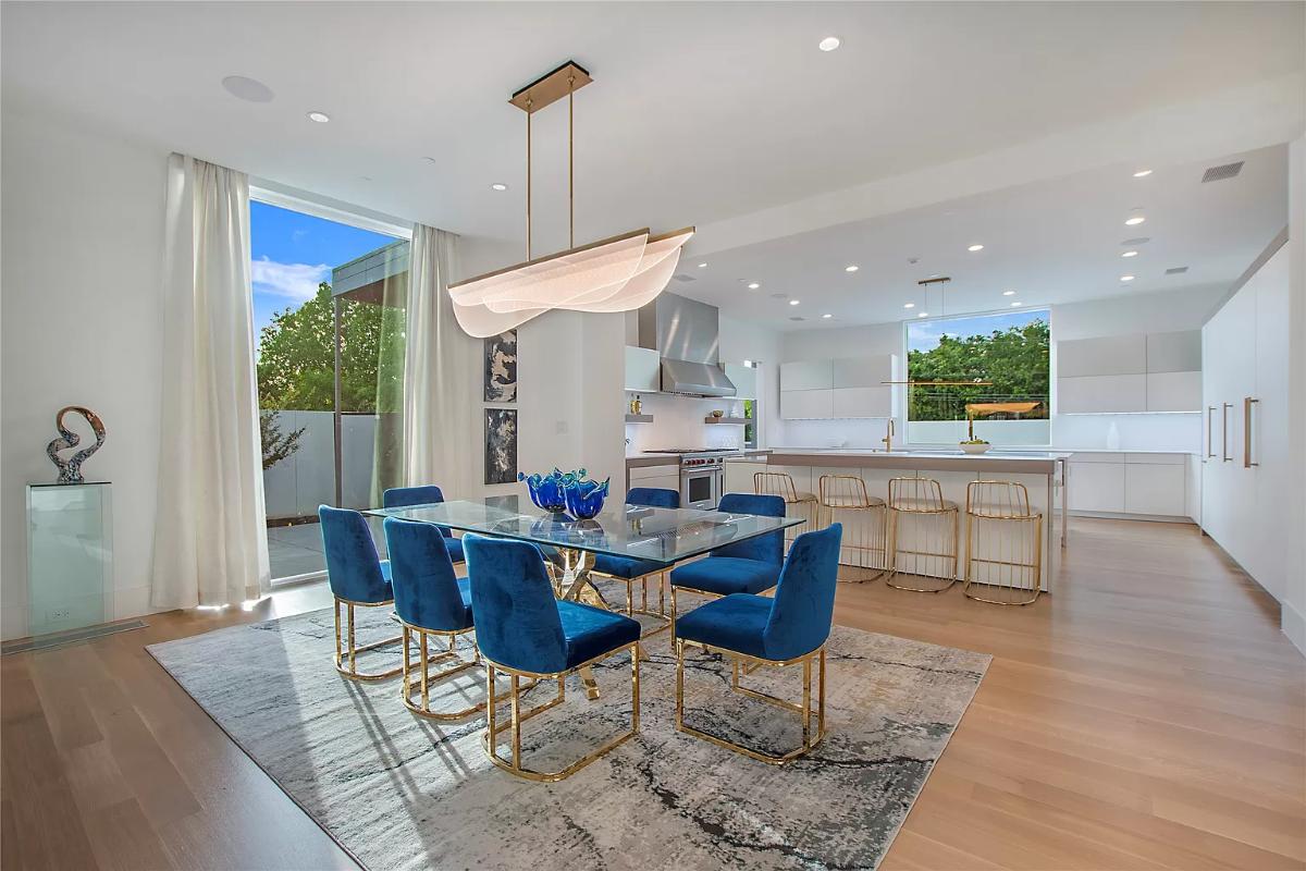 Dining room with a large glass table and chairs.