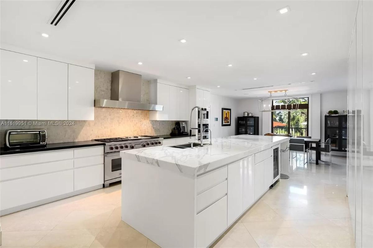 Kitchen with custom cabinetry and a center island prep area.