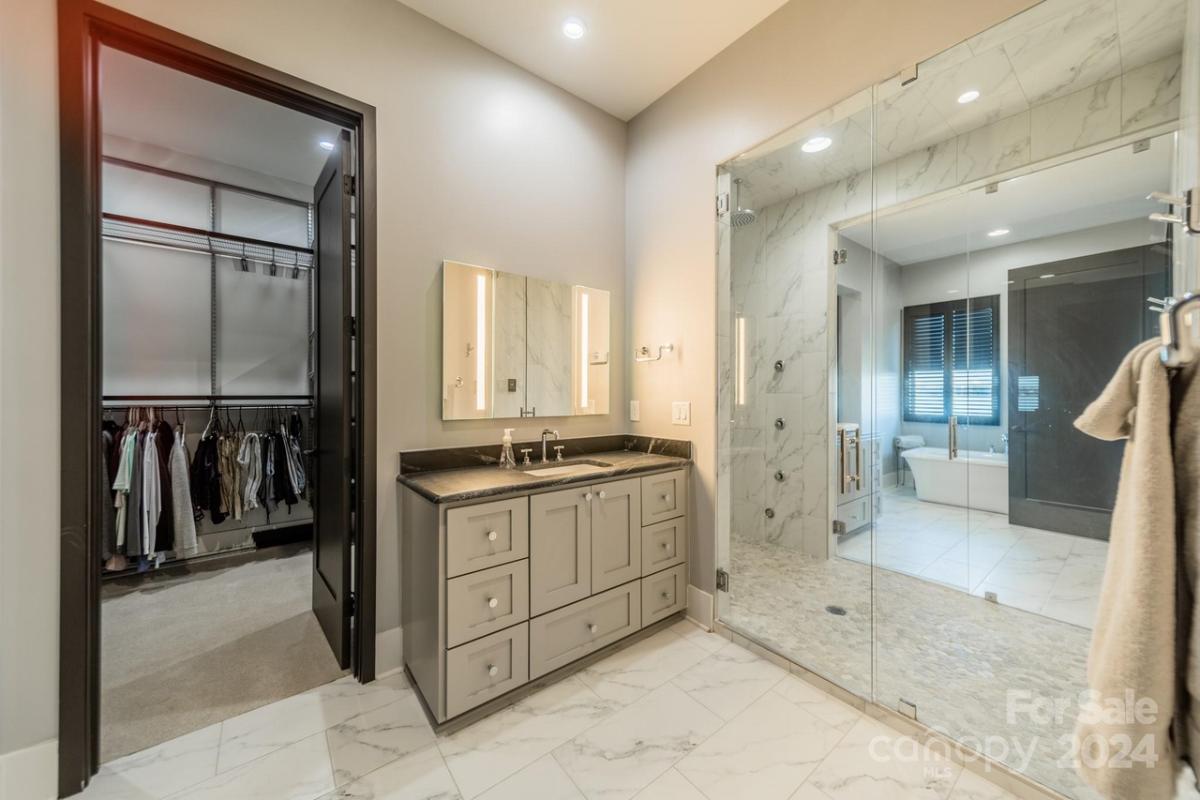 Bathroom with a custom-made vanity, soaking tub and a walk-in shower