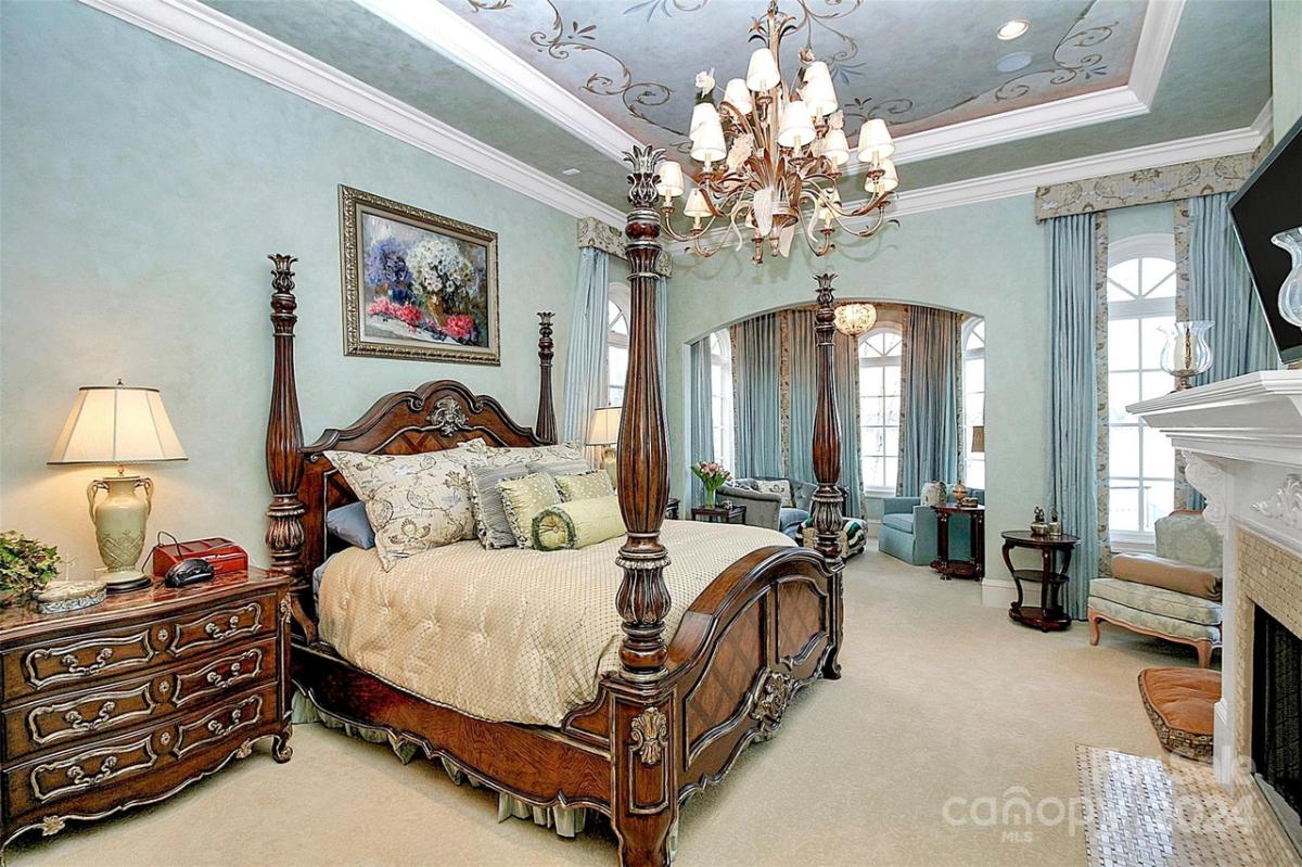 Bedroom with carpet flooring and a chandelier.